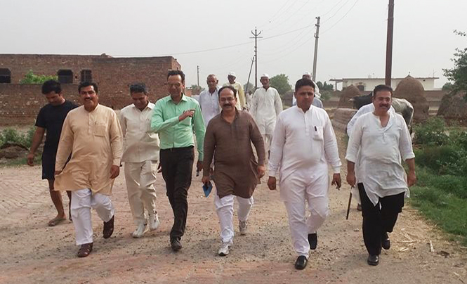 Walking through Budheda to identify prospective site of a martyrs memorial